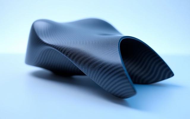 Sleek, single-piece carbon fiber structural component with complex curves, showcasing advanced manufacturing.